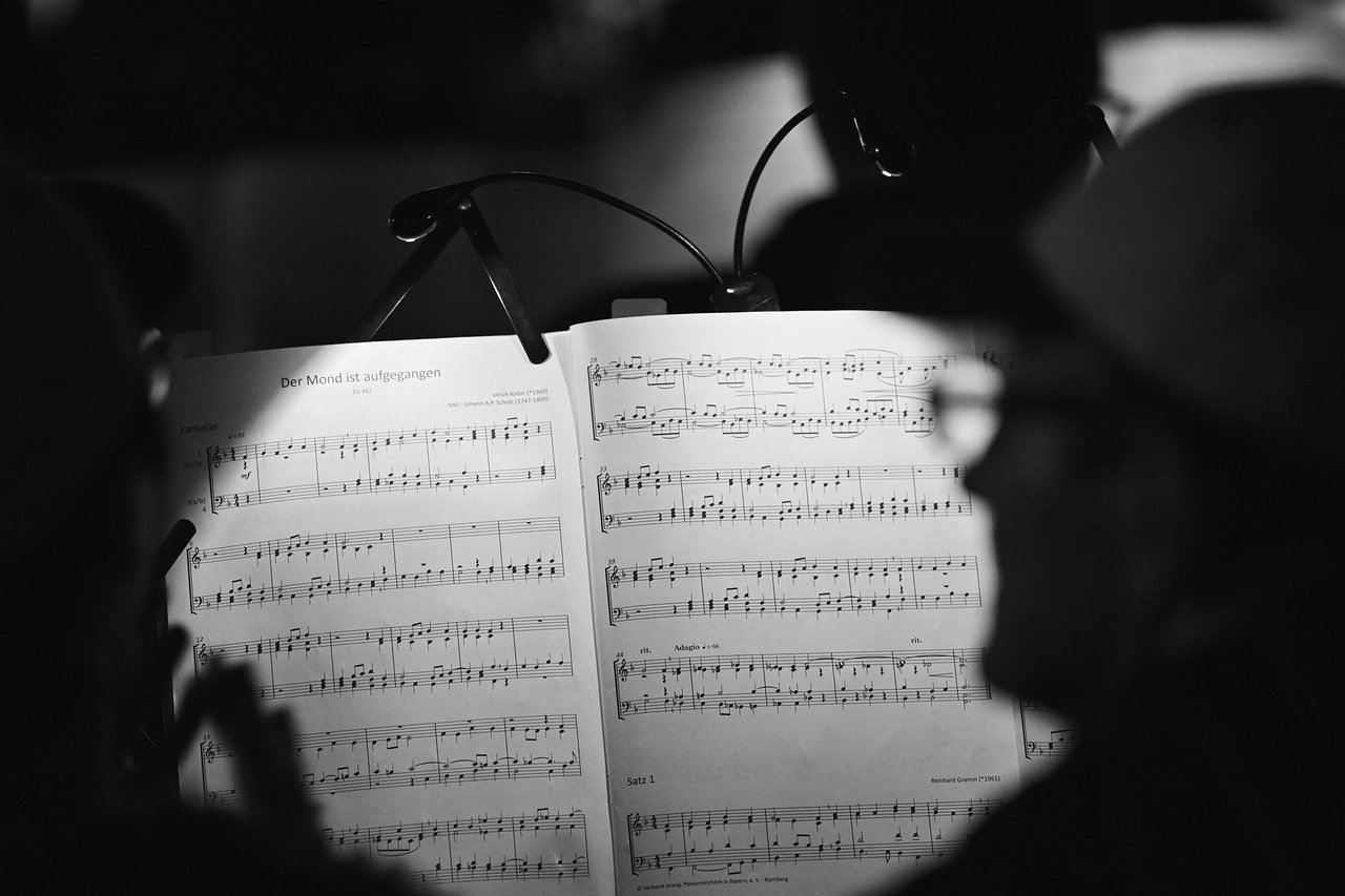 Sheet music illuminated by a stand light